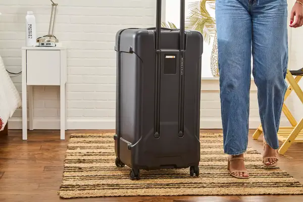 A person next to the Briggs & Riley Extra Large Trunk Spinner