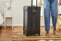 A person next to the Briggs & Riley Extra Large Trunk Spinner