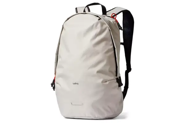 A person placing a laptop inside of a compartment in the Dagne Doverr Seattle Carry On Rolling Luggage 20.5