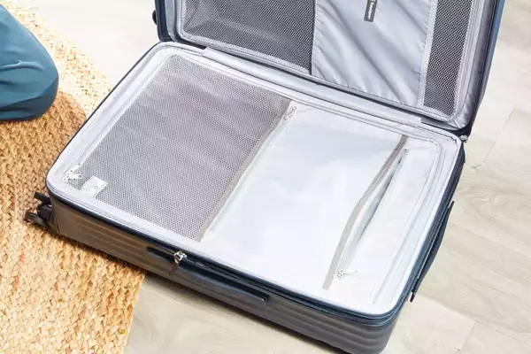 A empty Travelpro Maxlite Air Medium Check-In Hardside Spinner displayed on a floor