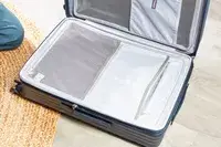 A empty Travelpro Maxlite Air Medium Check-In Hardside Spinner displayed on a floor