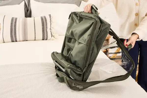 A person unzips the Lipault Foldable Plume Cabin