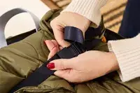 A person secures the strap on the Lipault Foldable Plume Cabin