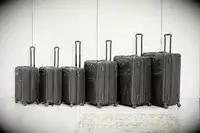 Six Tumi suitcases lined up