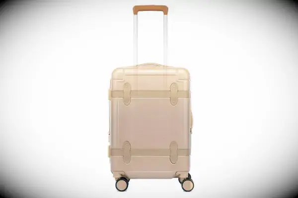 Person rolling the Samsonite Elevation Plus Large Softside Spinner on pavers