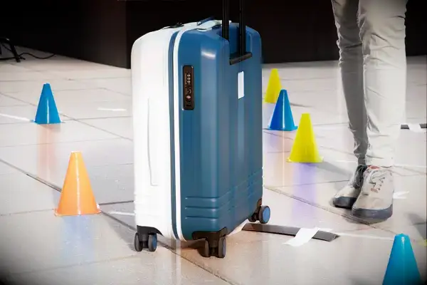 A person placing a water bottle in the Samsonite Elevation Plus Backpack