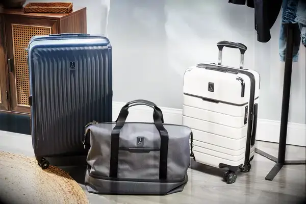 A variety of three Travelpro suitcases and bags on the floor