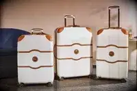 Three Delsey suitcases