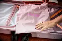 The laundry bag inside a Beis suitcase