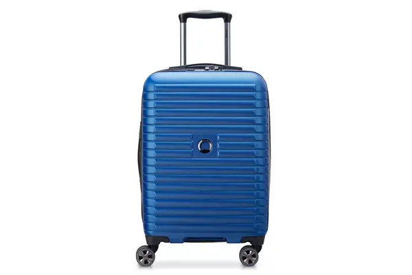 Person pushing the Delsey Chatelet Air 2.0 21-inch Carry-on Spinner off a counter