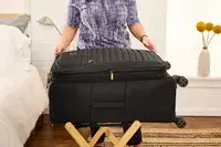 A person unzips the Delsey Paris Cruise 3.0 Soft Large Expandable Spinner