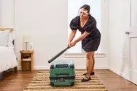 A person hits the Delsey X Jeep JH002B Large Expandable Spinner Trunk with a baseball bat