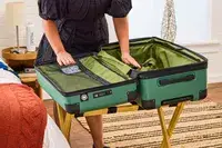 A person opens pockets on the Delsey X Jeep JH002B Large Expandable Spinner Trunk