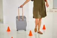 A person walking while rolling the Delsey Cruise 3.0 Carry-on - 21
