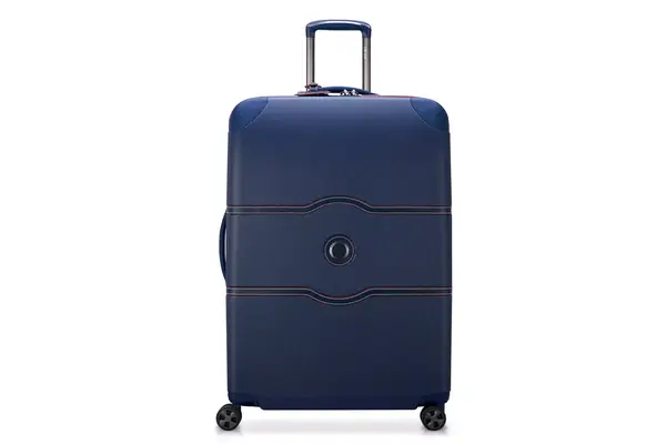 Person pushing the Delsey Chatelet Air 2.0 21-inch Carry-on Spinner off a counter