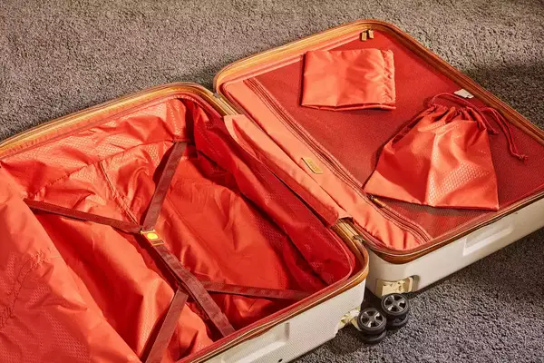 Delsey Paris Chatelet Air 2.0 28 Inch Large Checked Spinner laying on a carpet