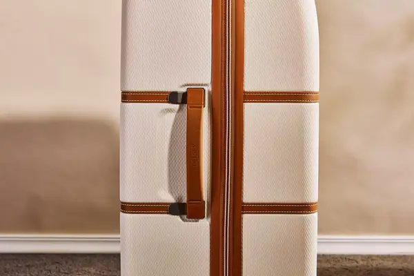 A close up of the side handle on the Delsey Paris Chatelet Air 2.0 28 Inch Large Checked Spinner