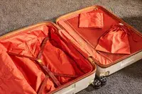 Delsey Paris Chatelet Air 2.0 28 Inch Large Checked Spinner laying on a carpet