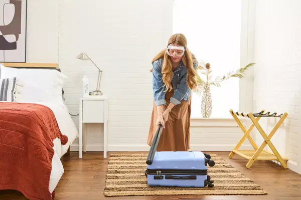 A person hitting the DELSEY PARIS X United Colors of Bennetton Carry-on Spinner with a bat