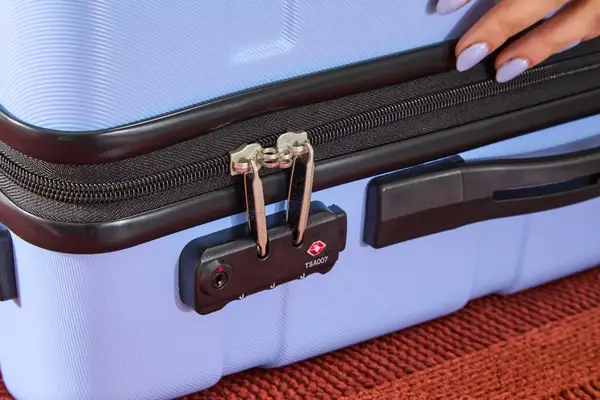 A close-up of the lock on the DELSEY PARIS X United Colors of Bennetton Carry-on Spinner