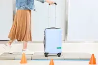 A person wheeling the DELSEY PARIS X United Colors of Bennetton Carry-on Spinner on tile