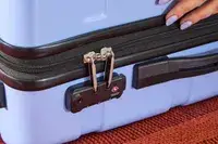 A close-up of the lock on the DELSEY PARIS X United Colors of Bennetton Carry-on Spinner