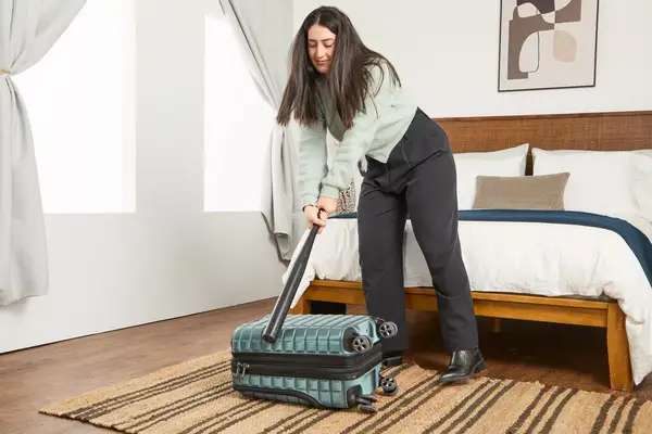 A person hits the Delsey Paris Shadow 5.0 Carry-on with Laptop Compartment with a baseball bat