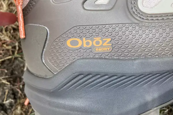 The logo on the Oboz Womenâs Katabatic Mid Waterproof Hiking Boots