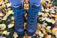 A person stands outside while wearing the Asolo Arctic GV Women’s Hiking Boot