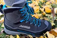A person walks in grass while wearing the Asolo Arctic GV Women’s Hiking Boot