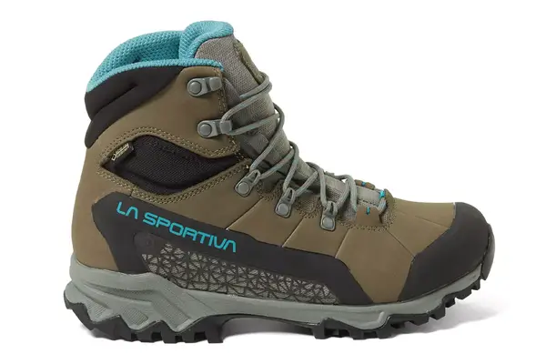 A woman wears Salomon X Ultra 4 Mid Gore-Tex Hiking Boots on top of a white carpet
