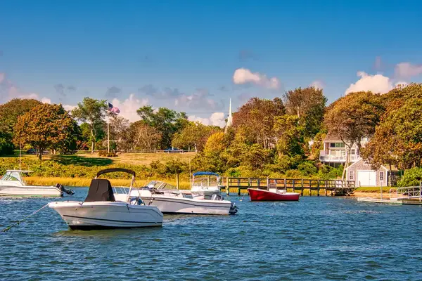 A few lingering powerboats are moored in Wychmere Harbor on Cape Cod on an October afternoon.