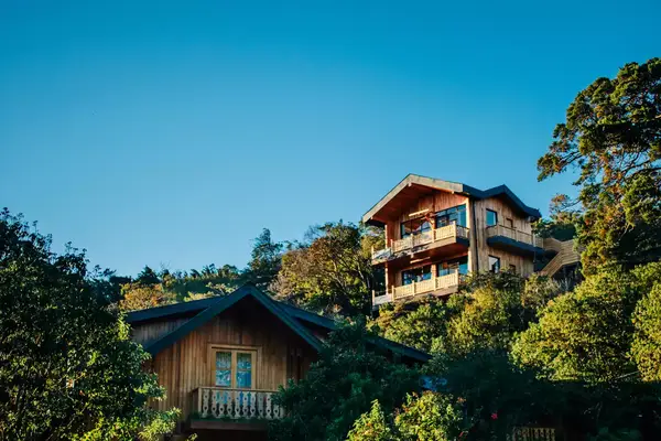 View of a hotel with a wooden facade set in lush greenery in Costa Rica