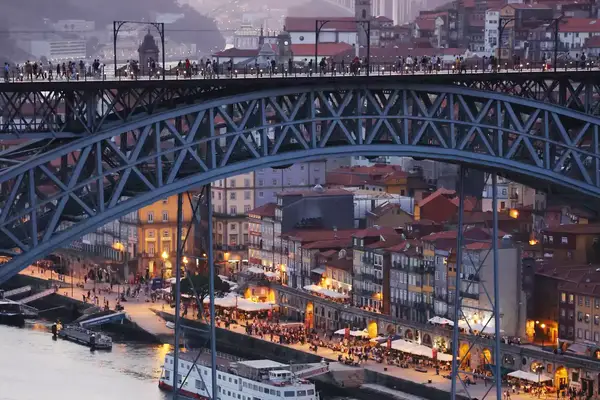 Busy waterfront with a bridge above