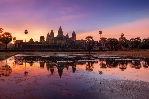 A purple, pink and yellow sky is seen over the horizon of Angkor Wat in Cambodia