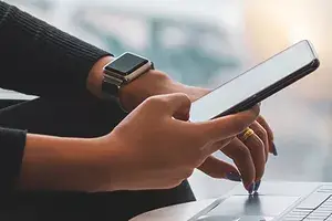 Woman working on laptop in airport hall