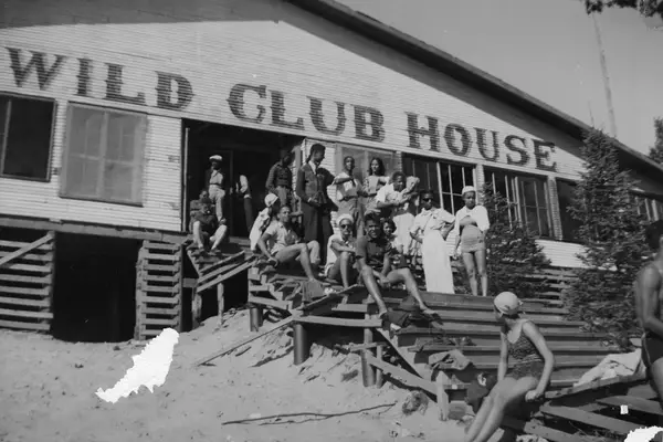 Portrait of unidentified people on the wooden steps of the Idlewild Club House, Idlewild, Michigan, September 1938.