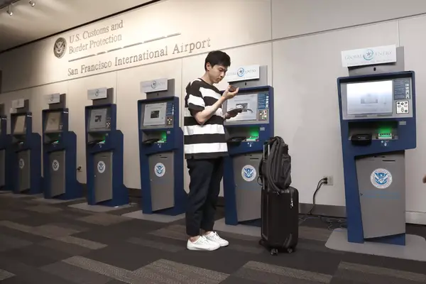 Kihyun Yoon checks in using the Global Entry computers at the U.S. Customs and Border Protection at the San Francisco International airport on Thursday, July 26, 2018 in San Francisco, Calif. 