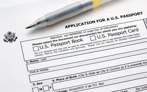 Paper application for U.S. passport book or card with ink pen.