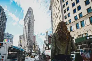 a woman standing on a busy NYC street