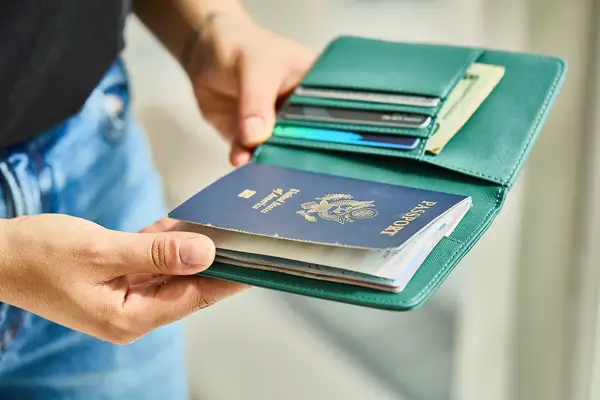 A person holding a passport holder