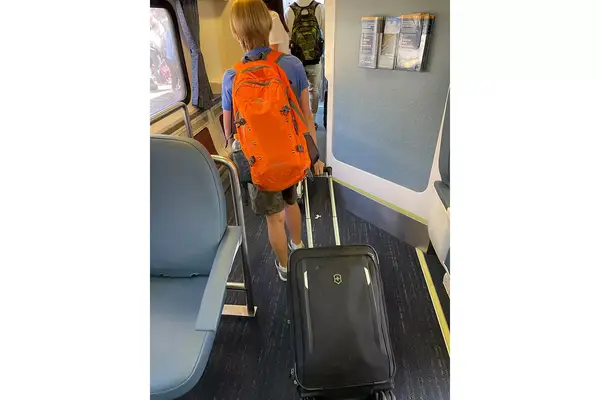 A child pulling a suitcase on board the Amtrak Pacific Surfliner train 