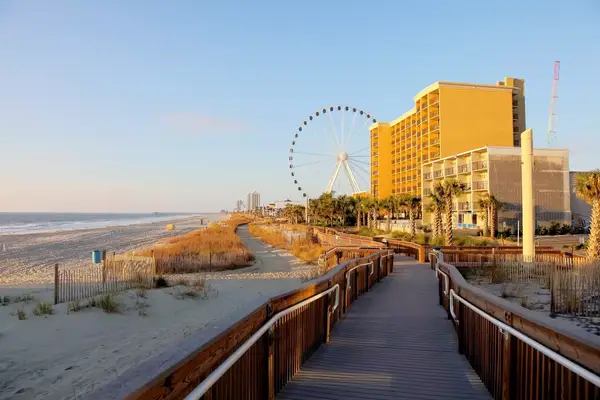 Beach boardwalk toward a ferris wheel in Myrtle Beach