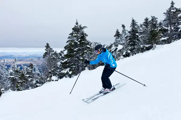 A female skier turns on Cannon Mountain, Franconia Notch State Park, New Hampshire.
