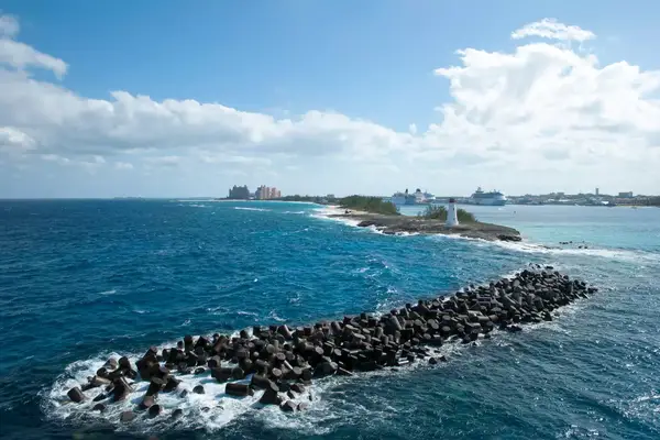 The view of Paradise Island with a lighthouse and Nassau Harbour with cruise ships (Bahamas).