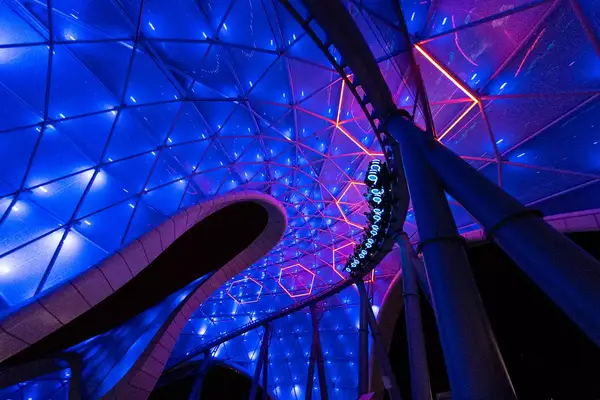 Guests on the TRON Lightcycle ride at Disney