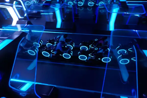 Guests on the TRON Lightcycle ride at Disney