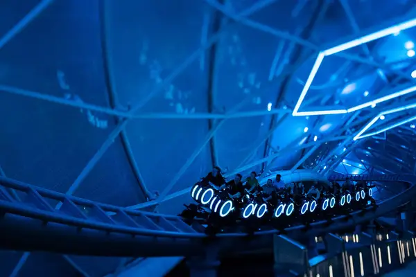 Guests on the TRON Lightcycle ride at Disney