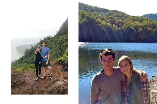 A couple posing on a mountain after hiking and standing in front of a lake 