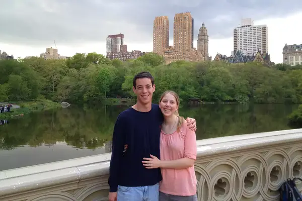 A couple posing on a bridge in Central Park, NYC